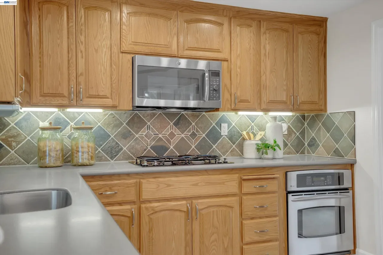 A closer view shows the broad counters, double sink, and under-cabinet lighting at 19475 Mount Jasper Drive.