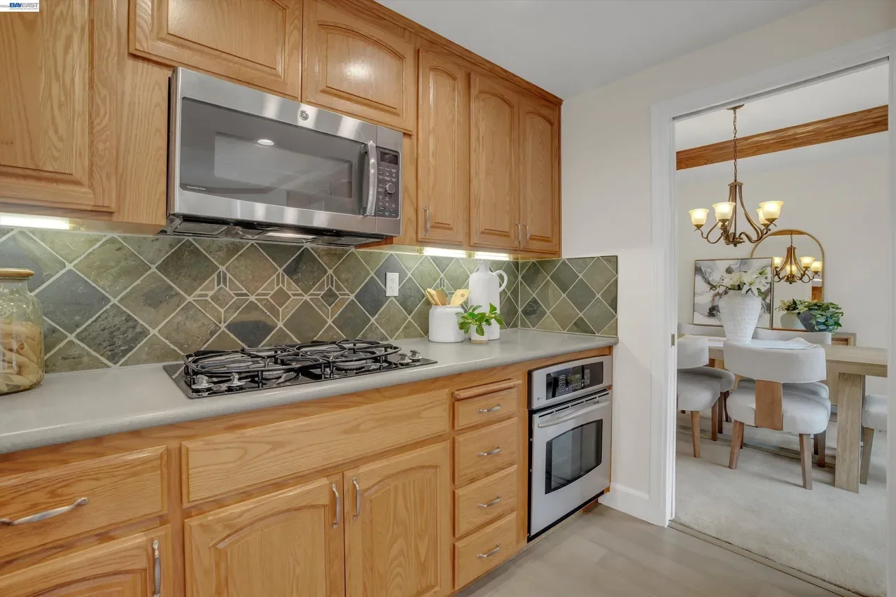 The gas cooktop, built-in oven, and microwave are grouped along the main cooking wall at 19475 Mount Jasper Drive.