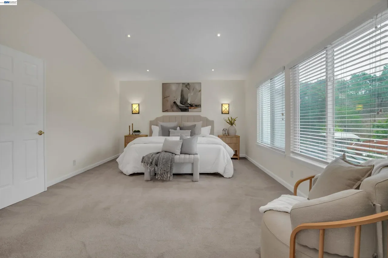 A second primary-bedroom angle shows the sitting area and generous floor space at 19475 Mount Jasper Drive.