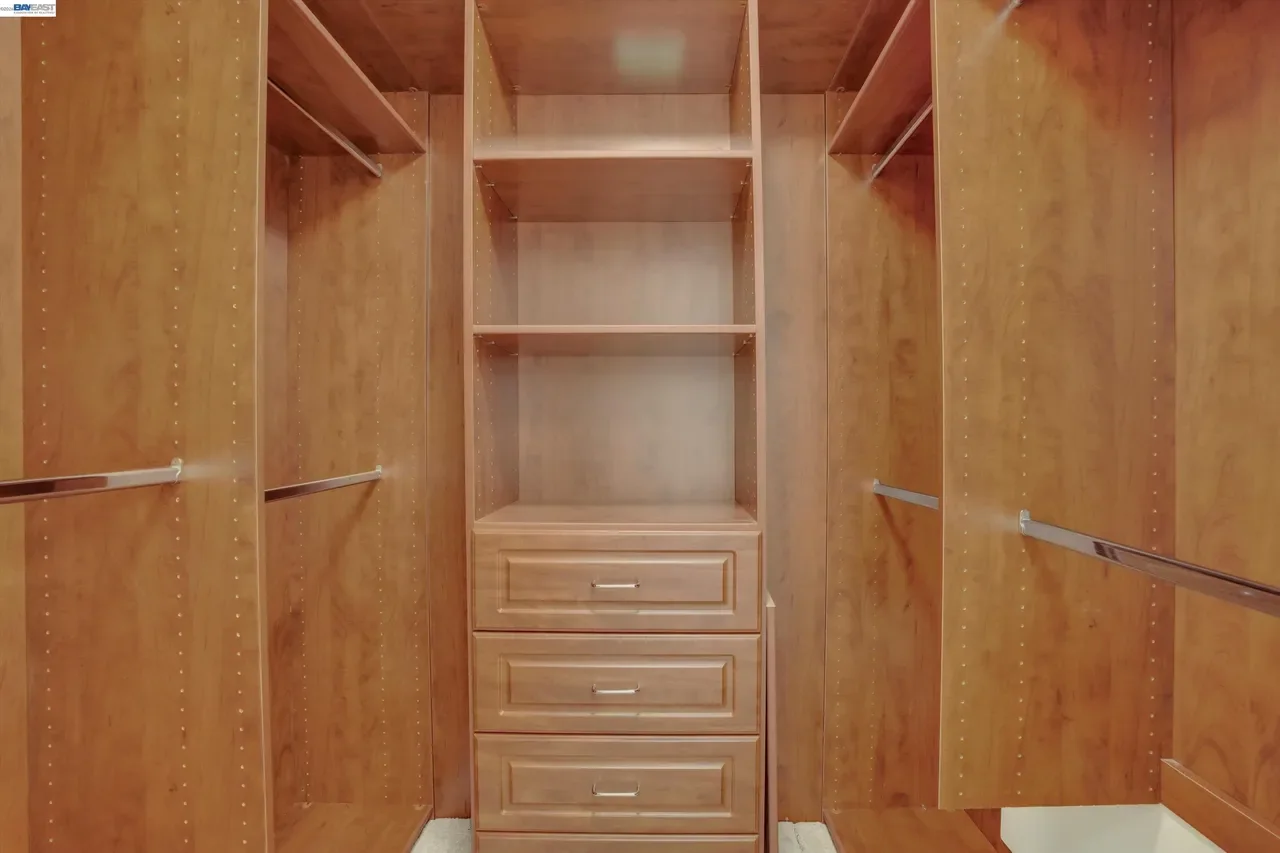 Built-in shelving and drawers organize the wood-lined walk-in closet at 19475 Mount Jasper Drive.