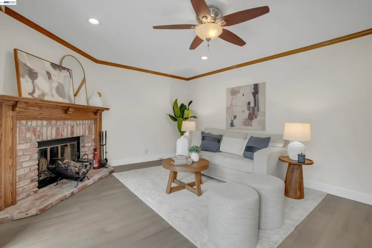 A brick fireplace anchors the family room beneath warm wood trim at 19475 Mount Jasper Drive.